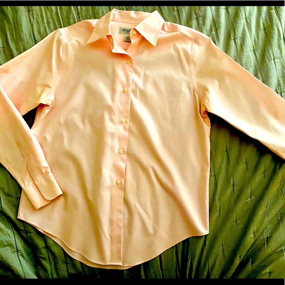 Pink long sleeved button down shirt.